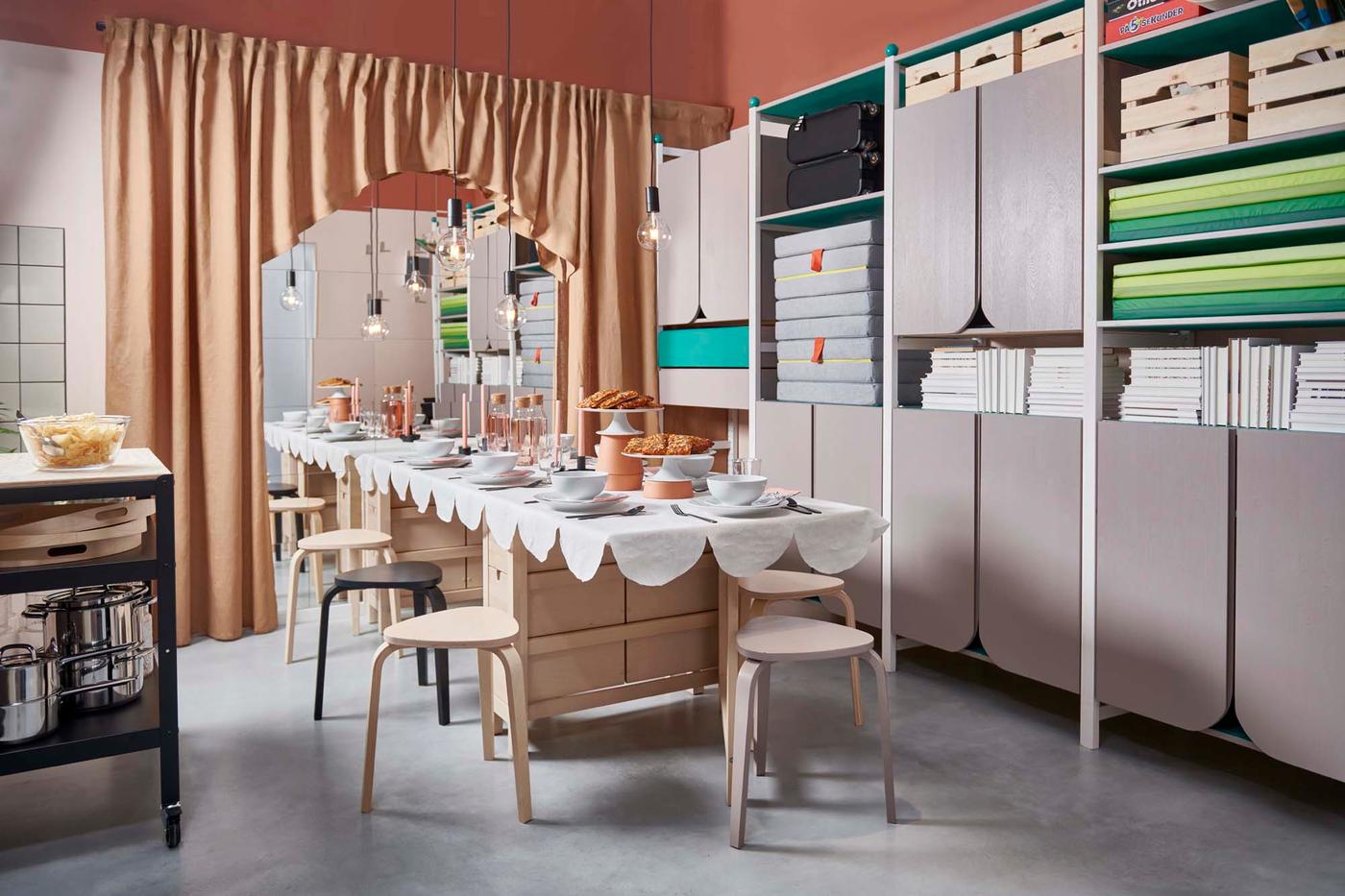 A room with a long table set for a celebration, and a wall-to-wall storage unit.