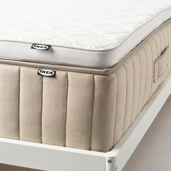 A white NYLÄGET mattress pad