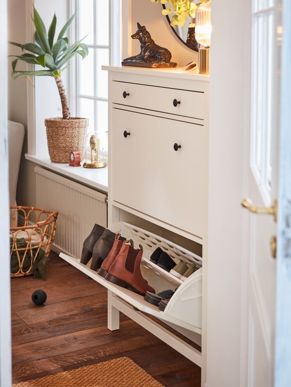 A white HEMNES shoe cabinet with 2 compartments in the hallway