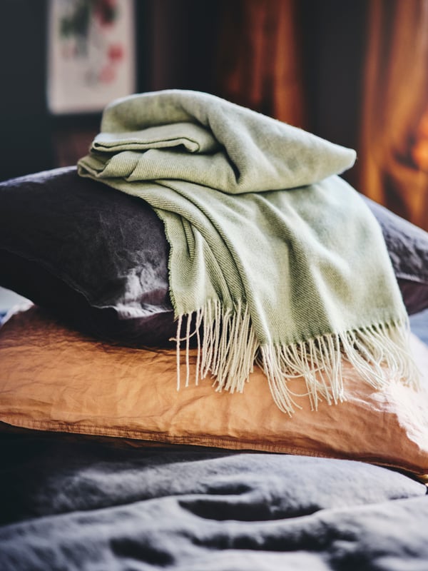 A light grey-green HOLMVI throw