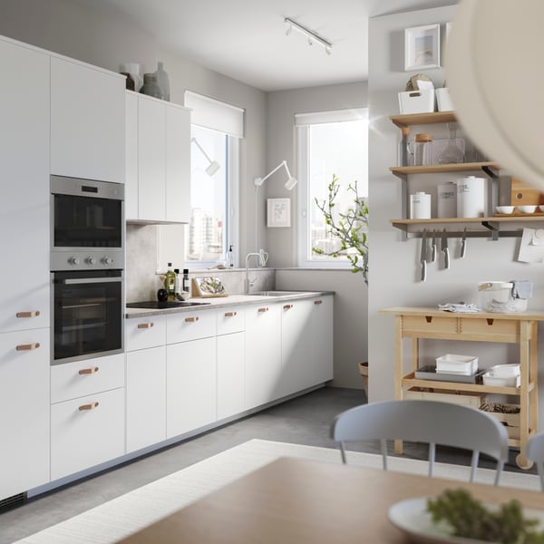 A white NYMÅNE wall lamp with swing arm