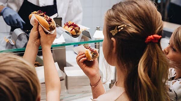 three-children-getting-veggie-hot-dogs-at-ikea-bistro-counter
